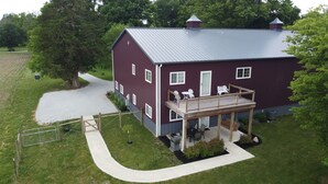 A two-story house with a balcony, a garage, and a driveway.