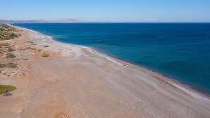 A coastal beach with a clear sky and calm sea. - Southrock Villas - 6 Bed Magnificent Seaview Villa with Private Pool New Listing (Lachania)