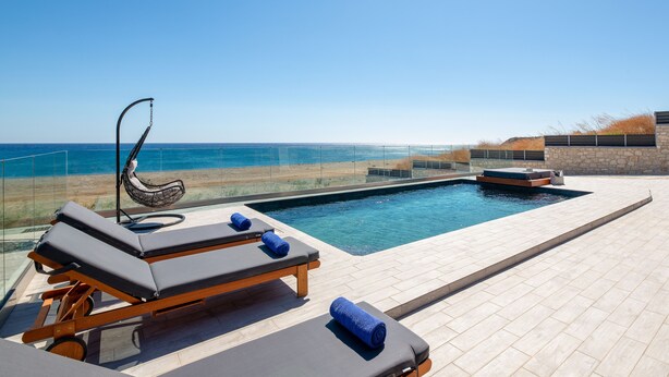 A rooftop pool with lounge chairs and a water feature. - Southrock Villas - 6 Bed Superb Seaview Villa with Private Pool (New Listing) (Lachania)