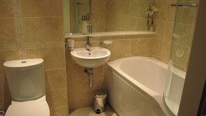 A bathroom with a toilet, sink, and bathtub.