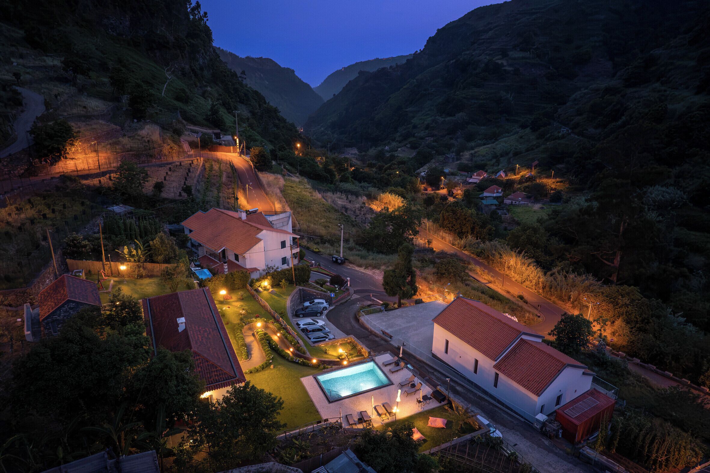 Un barrio residencial con casas, una piscina y una carretera sinuosa.