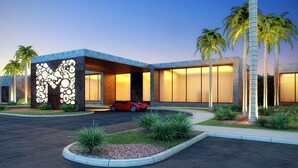 A modern building with a unique facade, large windows, and a red sports car parked in front. - Stunning 4 Bd Close to Disney Magic Village Resort 7537 (Kissimmee)
