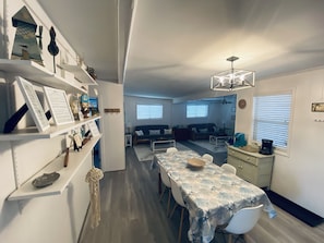 Relax in this inviting living space with a dining area for four, a cozy seating area, and a fully equipped kitchen.