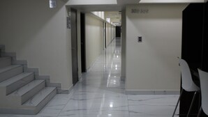 A hallway with marble flooring, a staircase on the left, and a door with the number 3019 on the right. - MISION 11 (Tijuana)