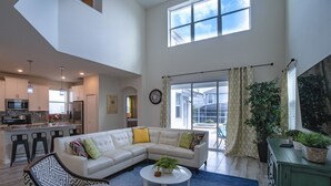A spacious living area with a sectional sofa, a coffee table, and a dining area with a bar. - Exclusive Villa with Breathtaking Views, Orlando Villa 4226 (Orlando)