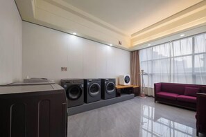 A modern laundry room with a sofa and a large window. - Ramada Hotel Zhangjiajie (Tianmen Mountain Cable Car Station) (Zhangjiajie)