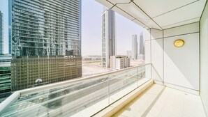 A modern interior with a glass balcony overlooking a cityscape. - Executive Towers Amazing 1BR Onsite Pool Business bay (Dubai)