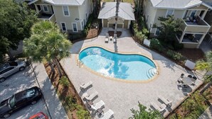 A swimming pool surrounded by lounge chairs and a covered patio area. - 2 Bikes! Steps to the Pool! Bike to Beach! 1st Fl Condo! - Silk Beach on 30A at Topsail Village (Santa Rosa Beach)