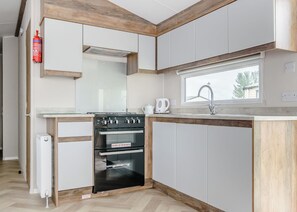 Fridge, oven, stovetop, toaster - 12ft-wide luxury caravan with one double and one twin. (Roman Bank, Skegness)