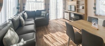 Modern and contemporary 12ft-wide caravan with one double and two twin.