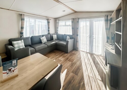 Modern and contemporary 12ft-wide caravan with one double and two twin.