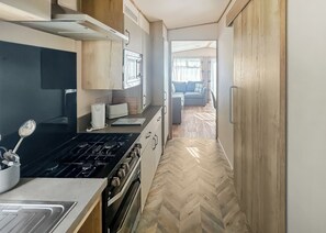 Fridge, oven, stovetop, toaster - Modern and contemporary 12ft-wide caravan with one double and two twin. (Bleadon, Weston-Super-Mare)