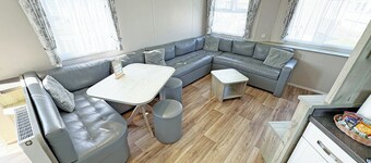 Modern and contemporary 12ft-wide caravan with one double and two twin.