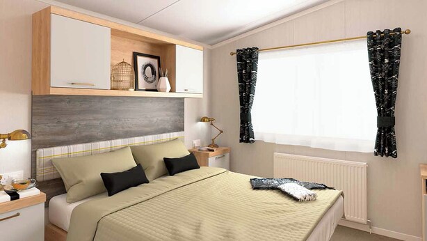 A neatly arranged bedroom with a bed, bedside tables, a shelf with decorative items, and a window with curtains.