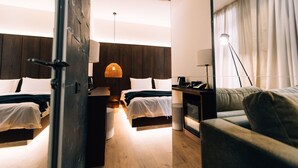A modern hotel room with two beds, a sofa, a desk, and a lamp. - FORest 1961 Hotel & Restaurant (Vanadzor)