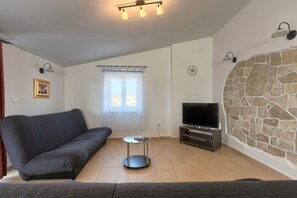 Relax in a comfortable living space with a sofa, coffee table, and flat-screen TV.
