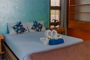 Relax in a cozy space with a comfortable bed, wooden headboard, and stylish storage.
