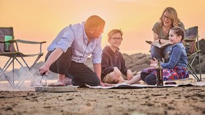 A family of four at a campsite with a tent and chairs. - Caravan with one double and two twin. (Prestatyn, Denbighshire)