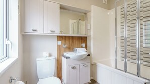 A bathroom with a toilet, sink, and shower area. - 2 bedroom accommodation in Calthwaite, Nr Penrith (Calthwaite, Nr Penrith)