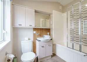 A bathroom with a toilet, sink, and shower area. - 2 bedroom accommodation in Calthwaite, Nr Penrith (Calthwaite, Nr Penrith)