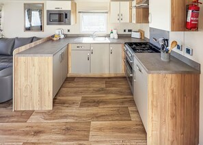 Fridge, oven, stovetop, toaster - Modern and contemporary 12ft-wide caravan with one double and one twin. (Bleadon, Weston-Super-Mare)