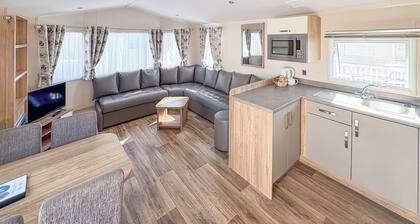 Modern and contemporary 12ft-wide caravan with one double and one twin.