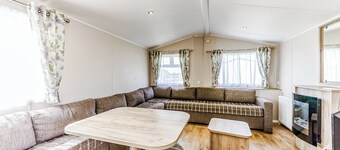 Modern and contemporary 12ft-wide caravan with one double and one twin.