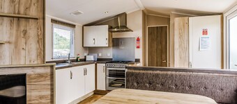 Modern and contemporary 12ft-wide caravan with one double and one twin.