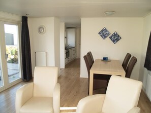 Enjoy meals in the dining area with a table and chairs, and take in the view from the large window.
