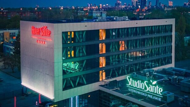 A modern building with a prominent 'Hotel Sante' sign on the left and 'StudioSante' on the right. - Hotel Sante (Warsaw)