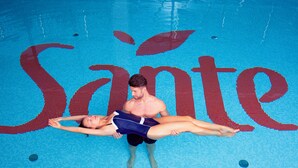 A swimming pool with a large red logo on the floor. - Hotel Sante (Warsaw)