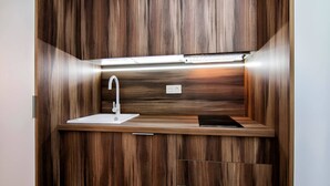 A modern kitchen with a built-in sink, a faucet, and a countertop.