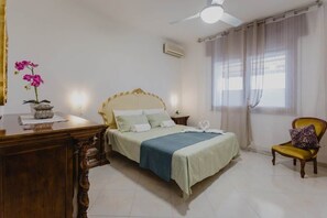 A bedroom with a bed, a desk, a chair, and a window with curtains. - To complete (Veneto)