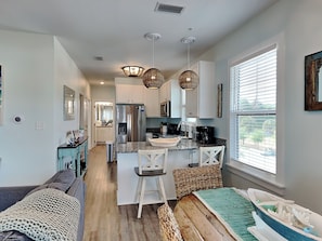 Enjoy cooking in this well-equipped kitchen with a central island, stainless steel appliances, and a dining area.