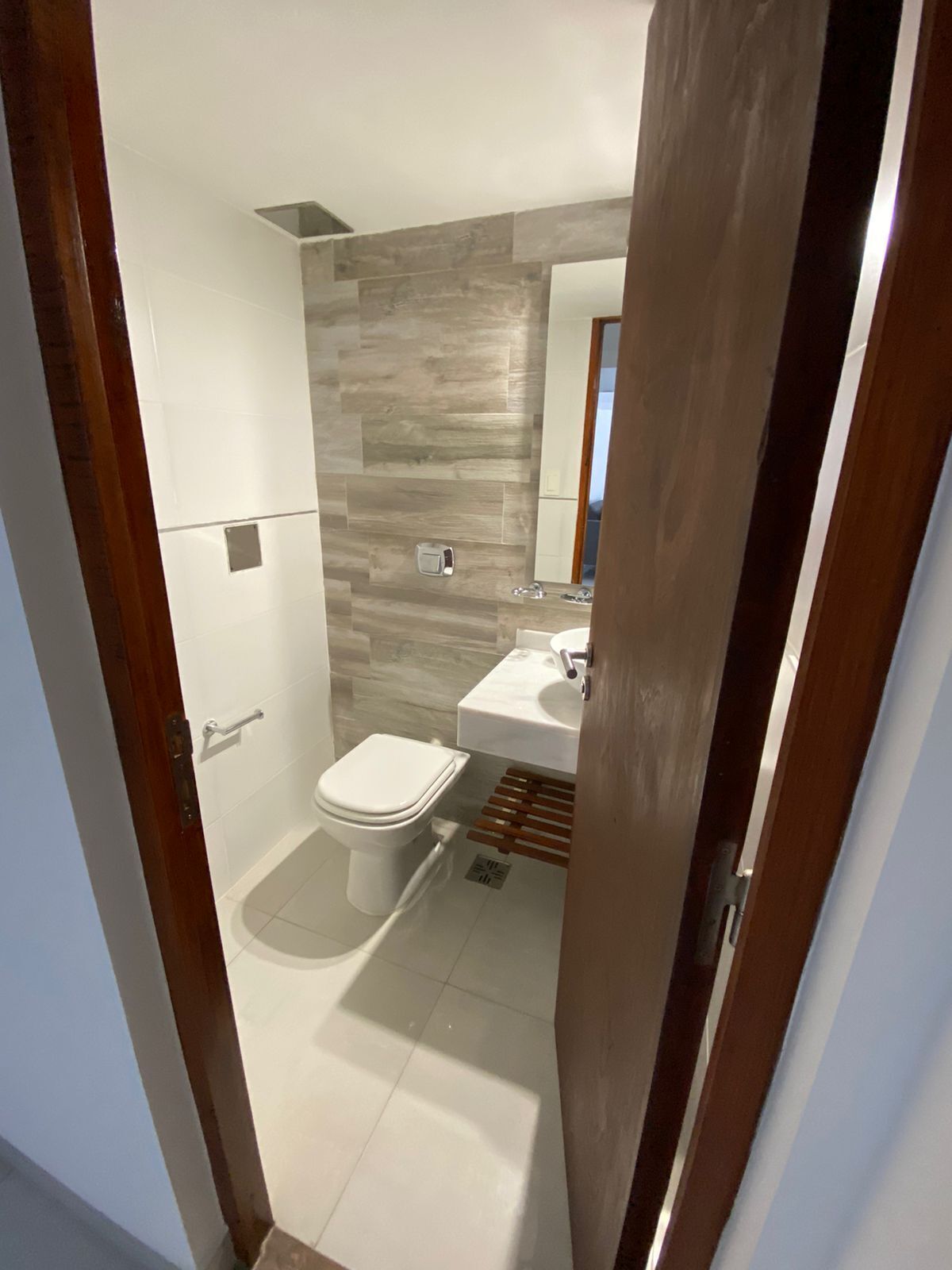 A bathroom with a toilet, sink, and shower.