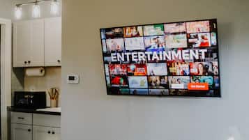 A wall-mounted screen displaying a grid of movie and TV show posters with the word "ENTERTAINMENT" prominently displayed.