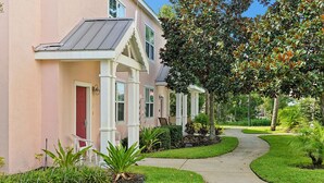 A row of houses with a pathway leading to the entrance. - Key West Vibe & Disney Thrills: Tropical Condo w/ Water Park (KIssimmee)