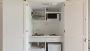 A compact kitchenette with a microwave, sink, and small refrigerator. - 3005 Dimora Donn`anna - Mono 1 by Barbarhouse (Ortelle)