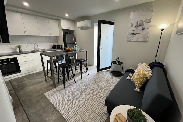 Open plan living kitchen with front door entrance