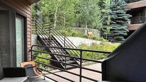 A balcony with a view of a deer in a natural setting. - Deer Valley Condo w/ Private Hot Tub (Park City)