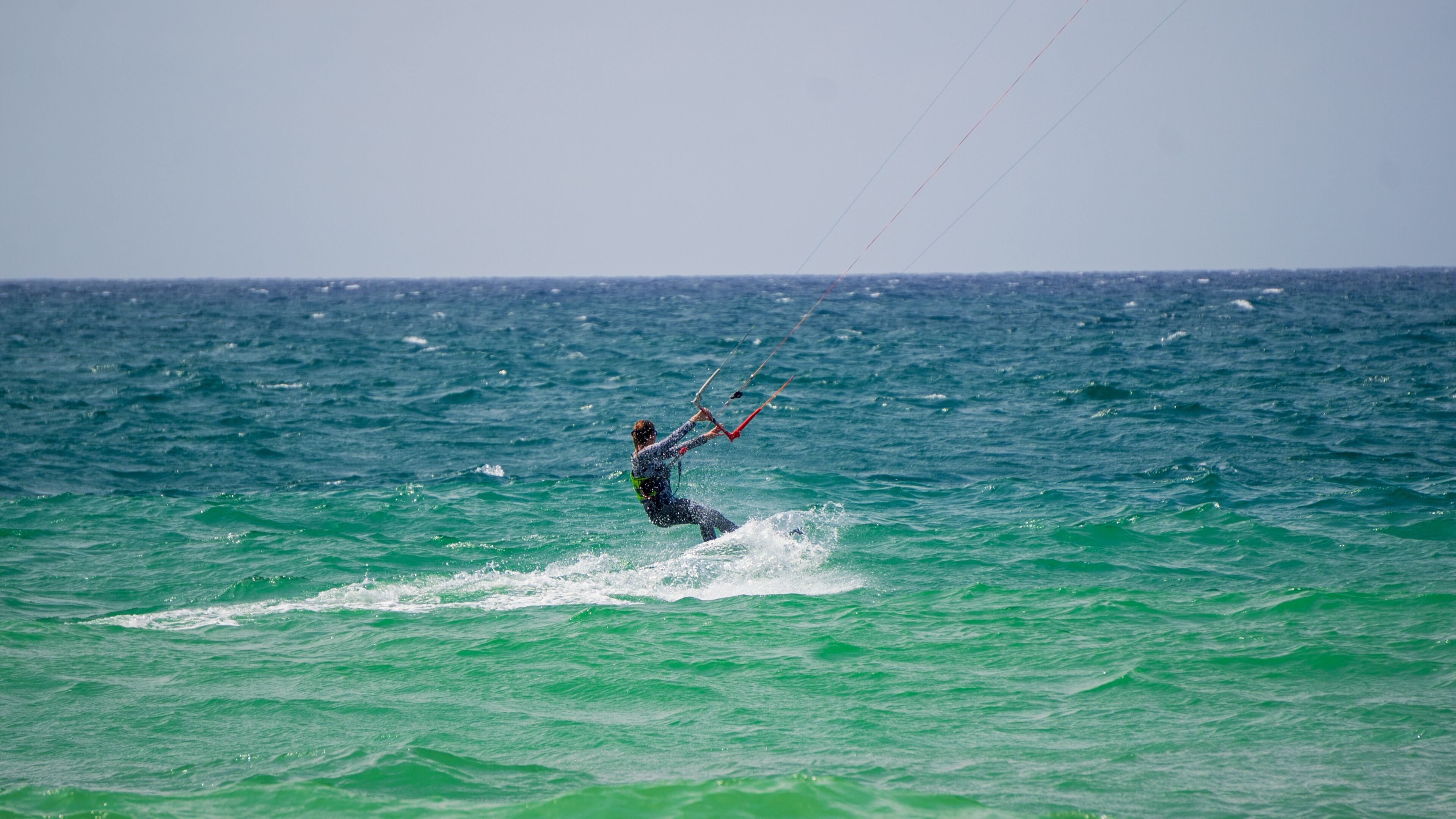 A person windsurfing on the ocean.