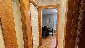 A wooden hallway with a dining area in the background. - Getaway Near Mass MoCA, Great Hiking, Scenic Views (Stamford)