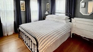 A bedroom with a bed, a nightstand, a dresser, and a ceiling light. - Getaway Near Mass MoCA, Great Hiking, Scenic Views (Stamford)