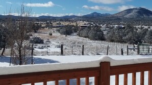 A snowy landscape with a wooden railing in the foreground, a clear blue sky, and distant mountains. - Comfy cabin for two close to Grand Canyon and many Northern Arizona attractions (Williams)