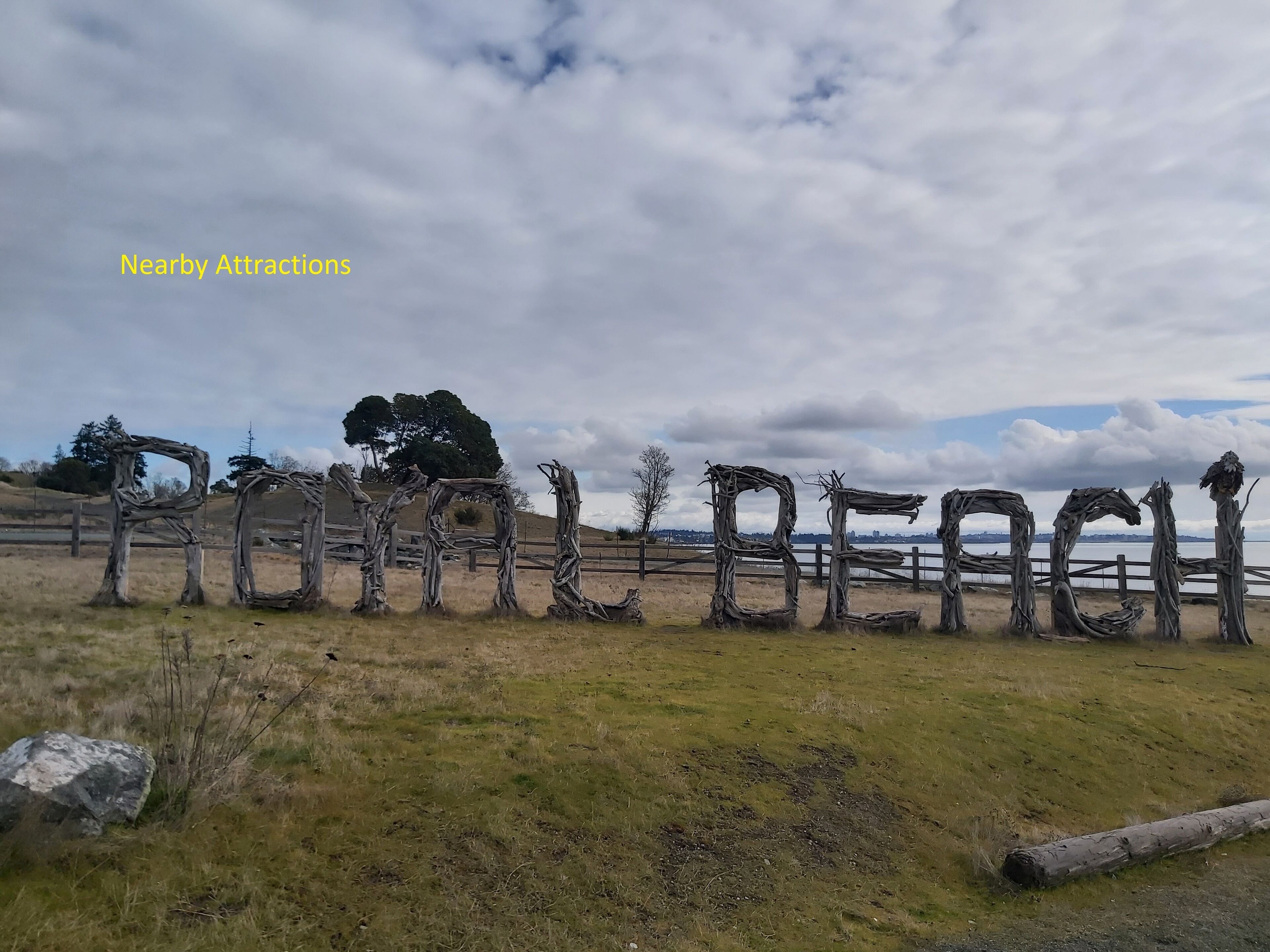 A rustic outdoor area with wooden structures resembling letters spelling 'ROAR BEACH'.