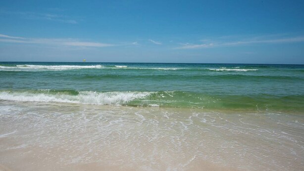 A beach with clear blue water and waves. - 2 complimentary Bikes! Directly on 30A! Beach access across the street! (Santa Rosa Beach)