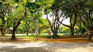 A park with trees, a bench, and a pathway.