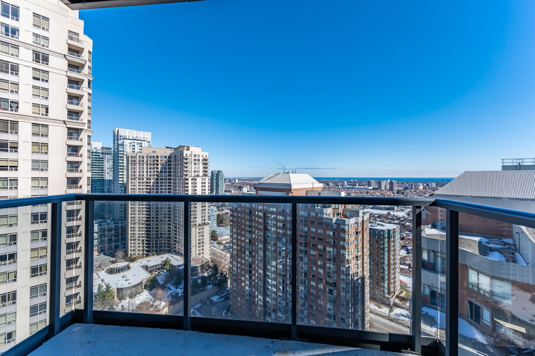 A high-rise building with multiple floors, large windows, and a clear view of the cityscape.