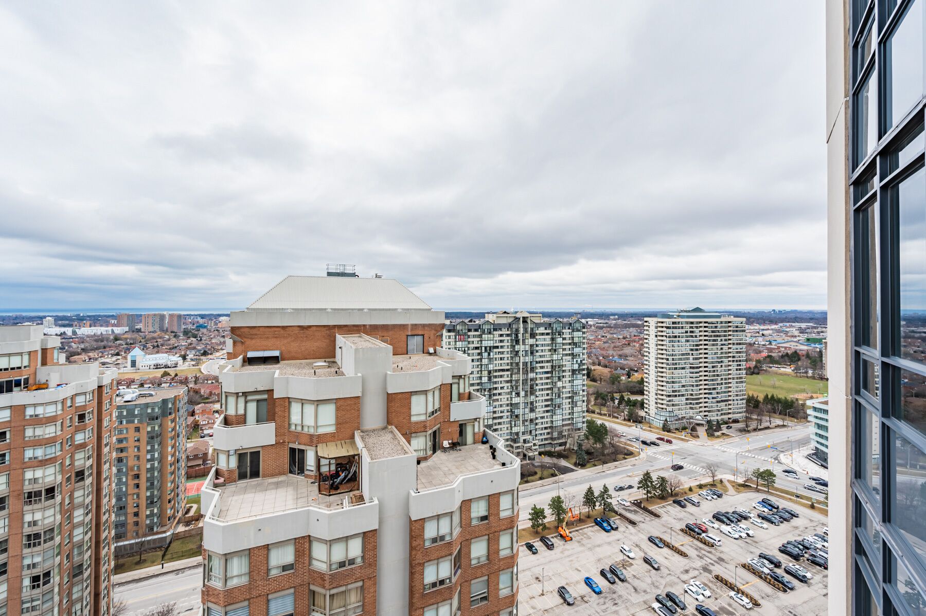 A high-rise building with a unique architectural design, featuring a mix of brick and glass elements.