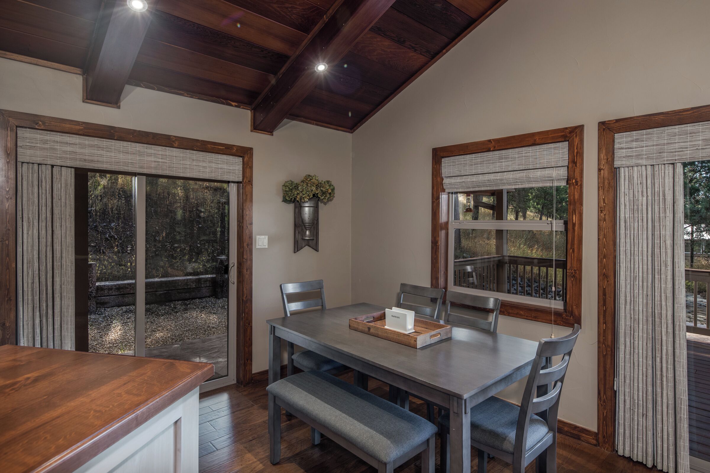 A dining area with a wooden table, chairs, and a bench.